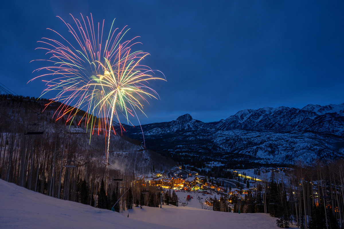 Colorful fireworks erupt over Purgatory Resort in winter.