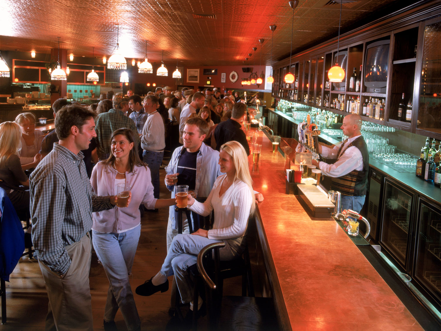 Lots of people crowd a copper bar in Copper Mountain.