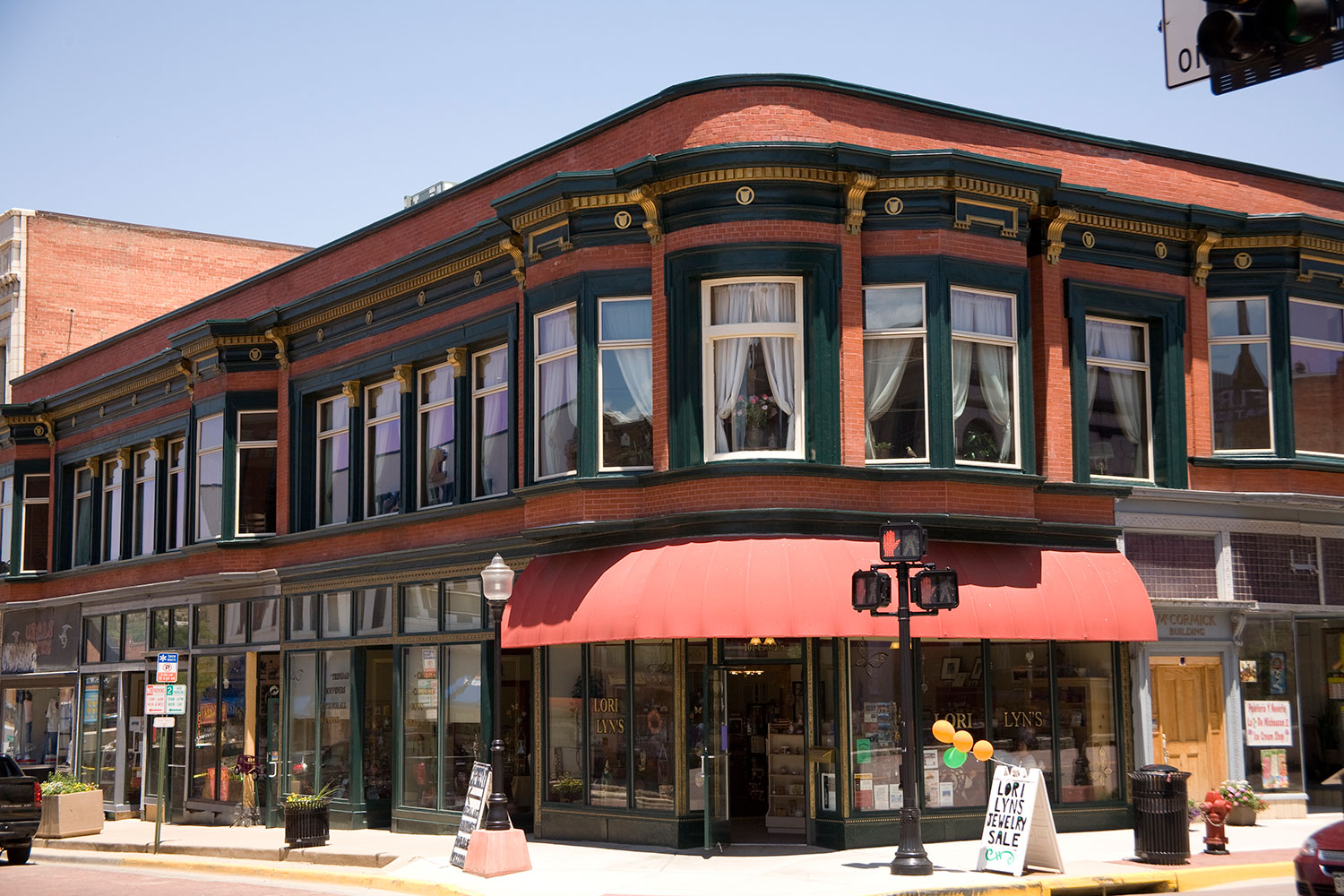 A brick building on a corner in El Corazón de Trinidad, the Trinidad Creative District on a sunny day
