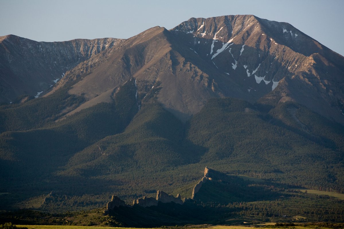 The dark mountains of La Veta with a bit of snow coverage and evergreen trees covering the lower sections near La Veta. 