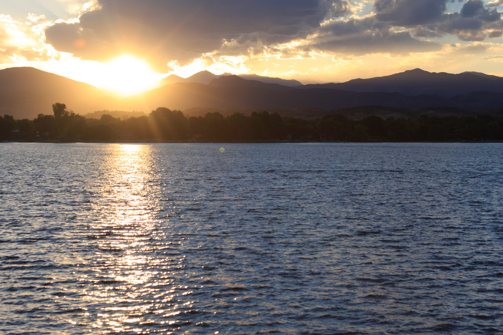 The sun sets behind the Front Range mountains above Lake Loveland. 