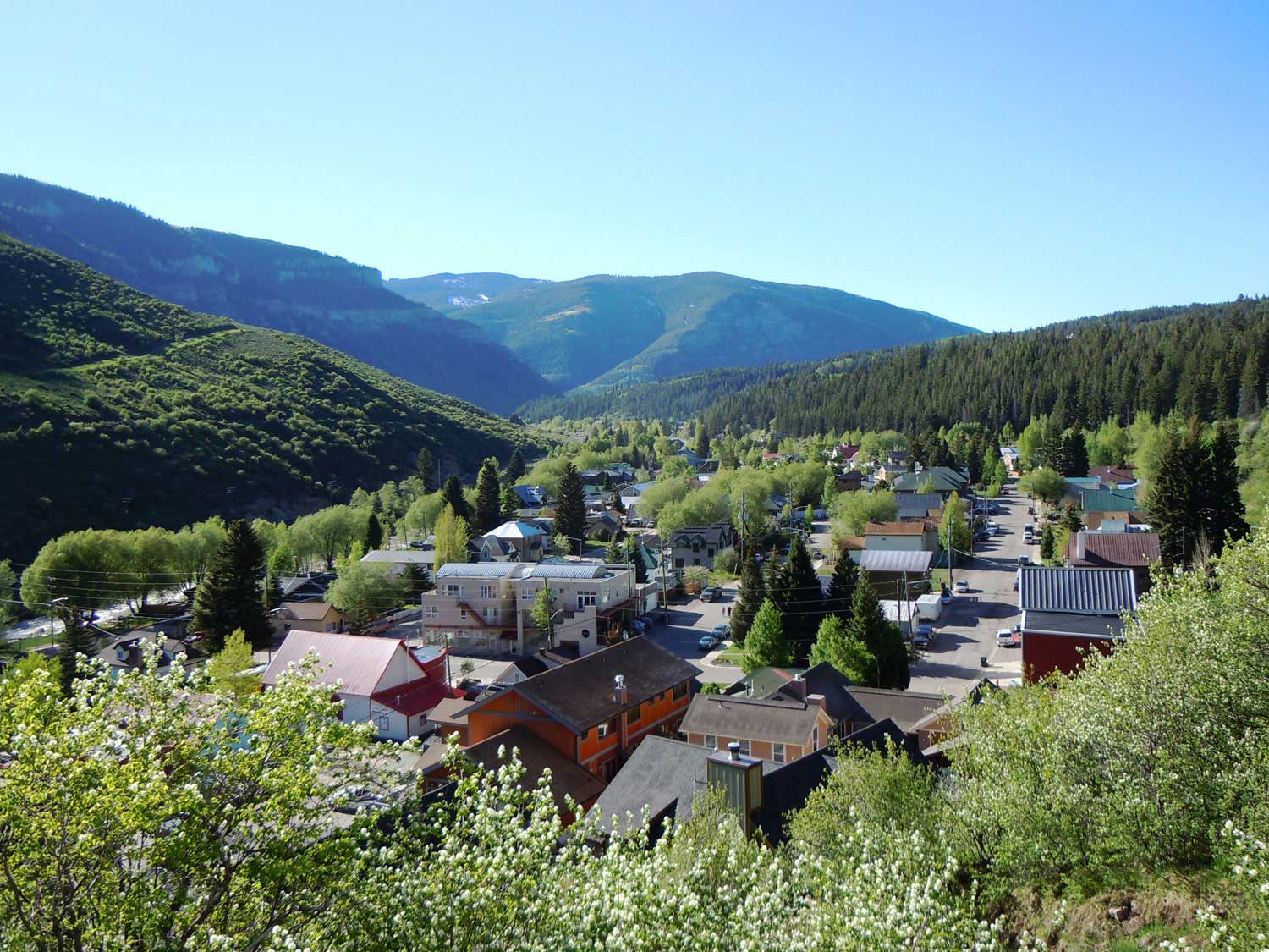 A sunny summer's day with a view of Minturn with hazy mountains in the distance.