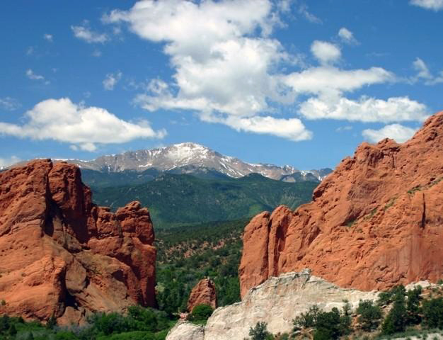 A gap between two red-rock formations at the Garden of the Gods, in Colorado, offers a glimpse of the snowy top of Pikes Peak.