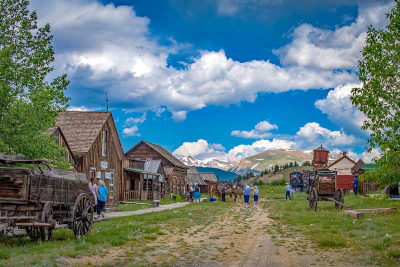 Visitors wander around the rustic, wooden buildings and wagons are on display outside at the South Park City Museum in Colorado.