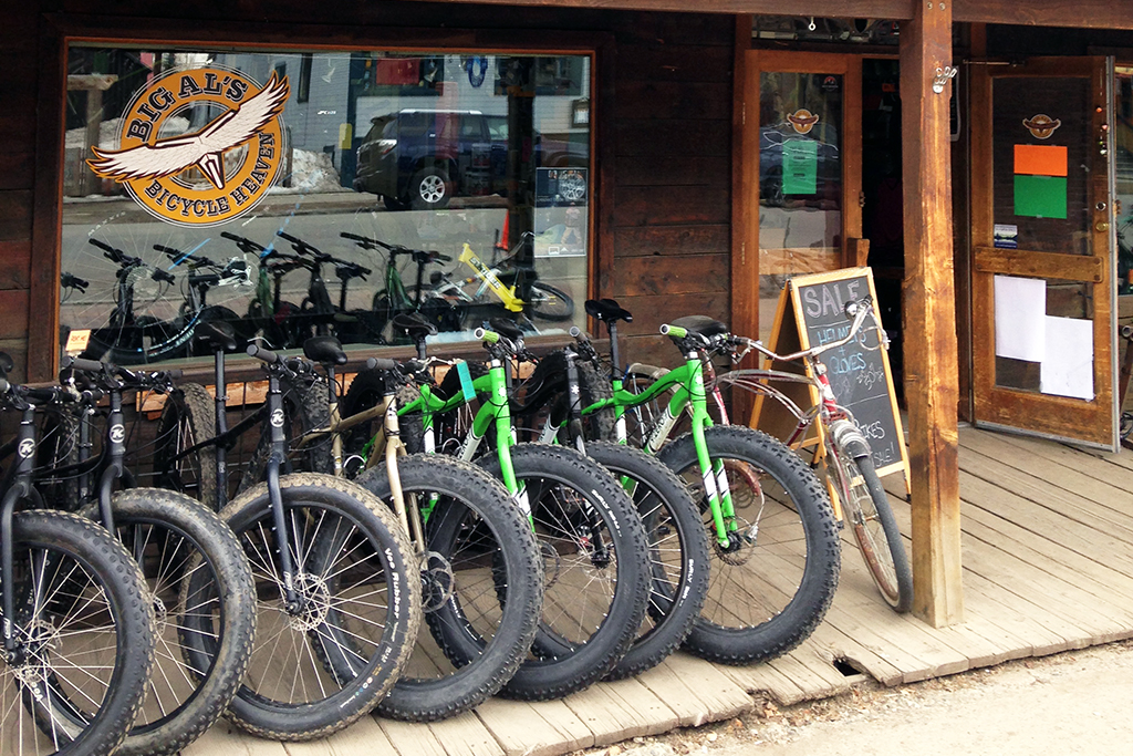 A neat row of grass-green- and black-framed fat-tire bikes sits on the dusty wood-plank porch of Bigal's Bicycle Heaven in Crested Butte, Colorado.