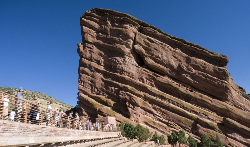 Red Rocks Amphitheatre's towering sandstone rock formations in Morrison, CO on a sunny day with blue skies