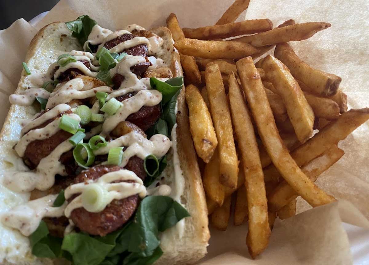 delicious cajun french sandwich and a side of fries photo