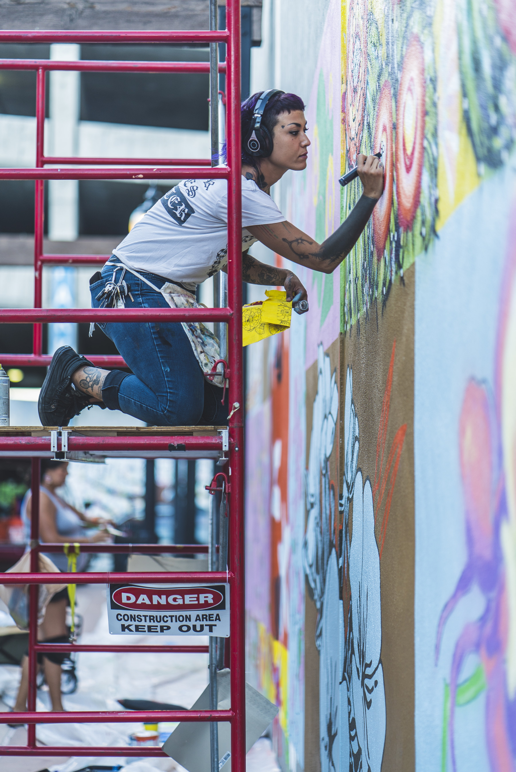 an artist painting a mural downtown. photo by devon balet photo 10