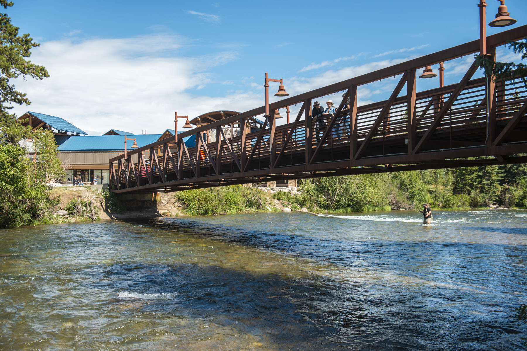blue village on walking bridge summertime photo